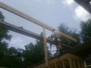 Carpenter setting a ridge beam over a new addition frame — Ice Dam Removal by Roofing Brothers in West Brookfield