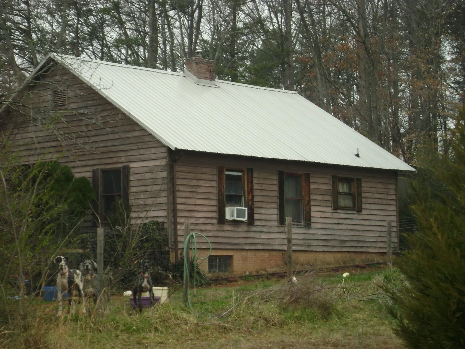 White metal roof on an old wood sided farmhouse, from a Metal Roof Installation job in West Brookfield